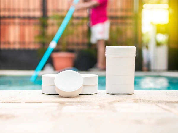 Disinfection tablets at the edge of a clean swimming pool