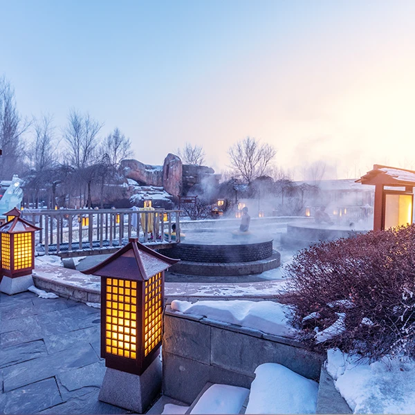 People soaking in an outdoor hot spring in winter