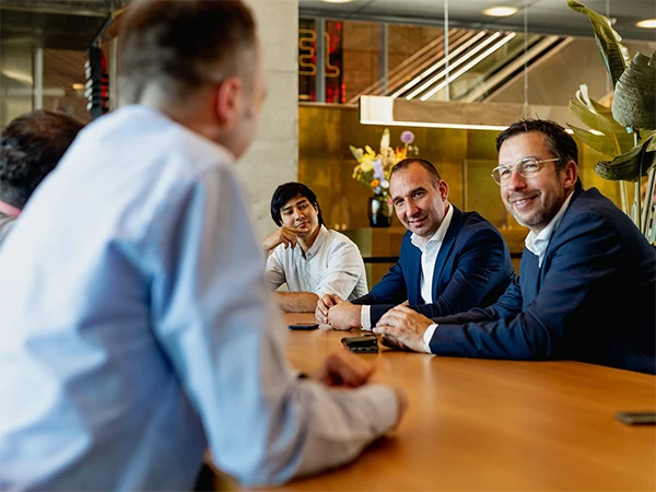 Sitting at the conference table discussing with the customer